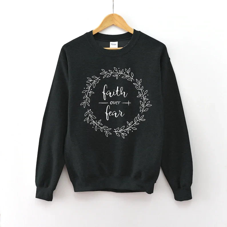 Black Women's Cotton Sweatshirt featuring 'Faith Over Fear' wreath graphic. 100% cotton Christian apparel by Faith Apparel.