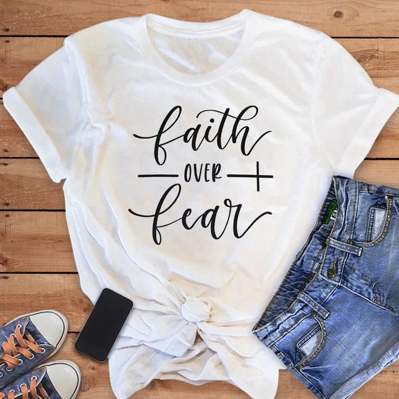 BC Faith Over Fear Christian T-Shirt in soft pink with black graphic slogan, styled with casual shoes, sunglasses, and roses for women’s fashion.