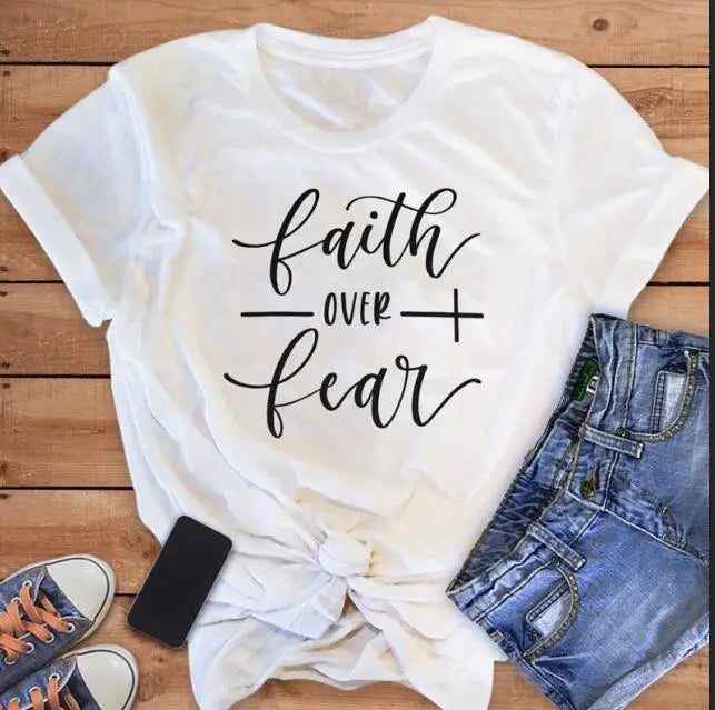 BC Faith Over Fear Christian T-Shirt in soft pink with black graphic slogan, styled with casual shoes, sunglasses, and roses for women’s fashion.