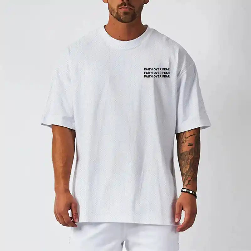 Model wearing BC Oversized Quick Dry Running T-shirt - Faith Over Fear. Lightweight and breathable for active lifestyle comfort.