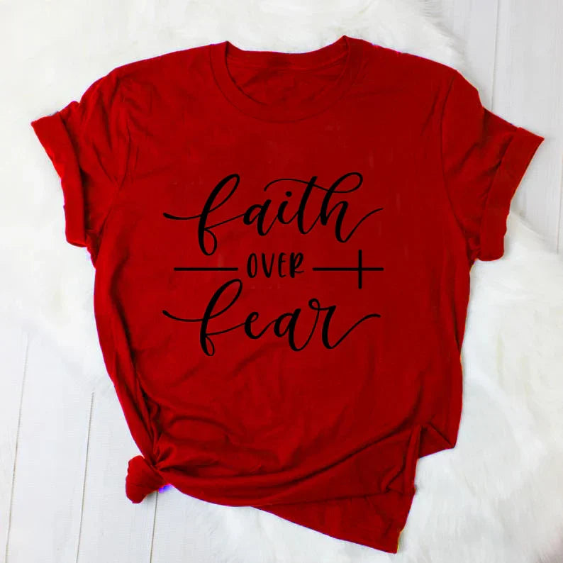 BC Faith Over Fear Christian T-Shirt in soft pink with black graphic slogan, styled with casual shoes, sunglasses, and roses for women’s fashion.