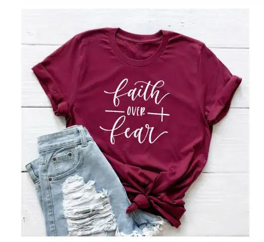 BC Faith Over Fear Christian T-Shirt in soft pink with black graphic slogan, styled with casual shoes, sunglasses, and roses for women’s fashion.